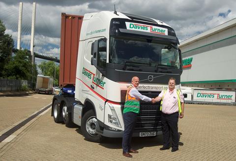 Left to right: Tony Cole with Dave Perfect and the new Volvo sign written in Davies Turner livery